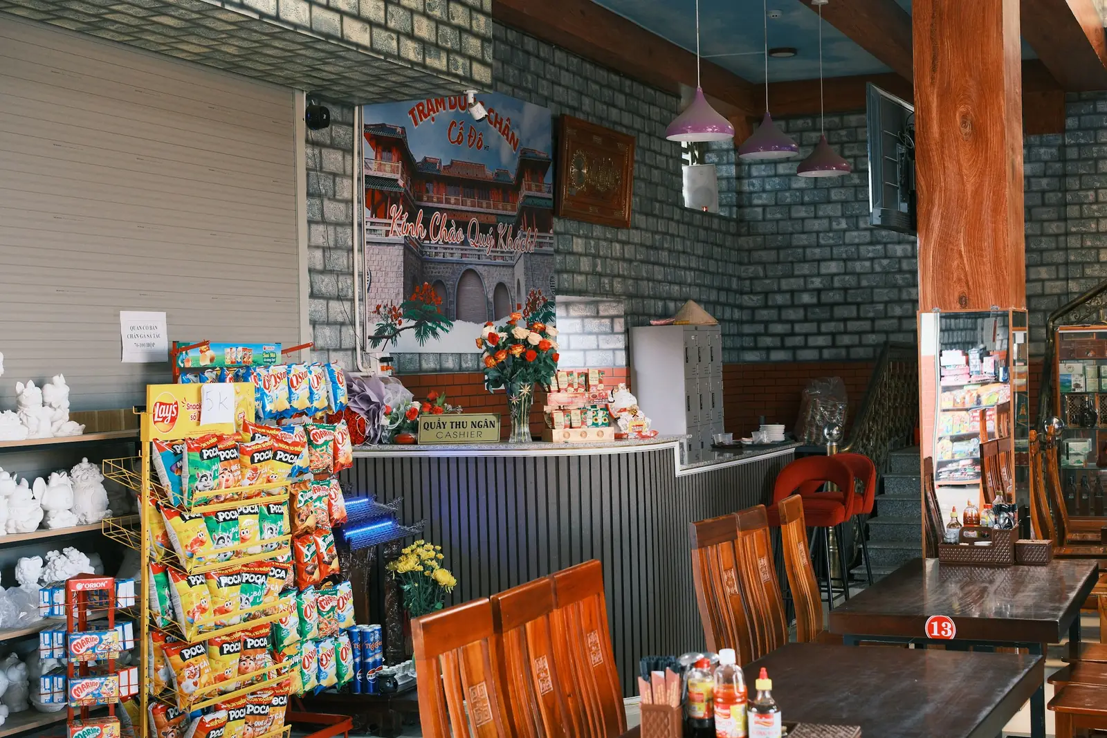 Interior of a small shop with shelves of goods and a counter.