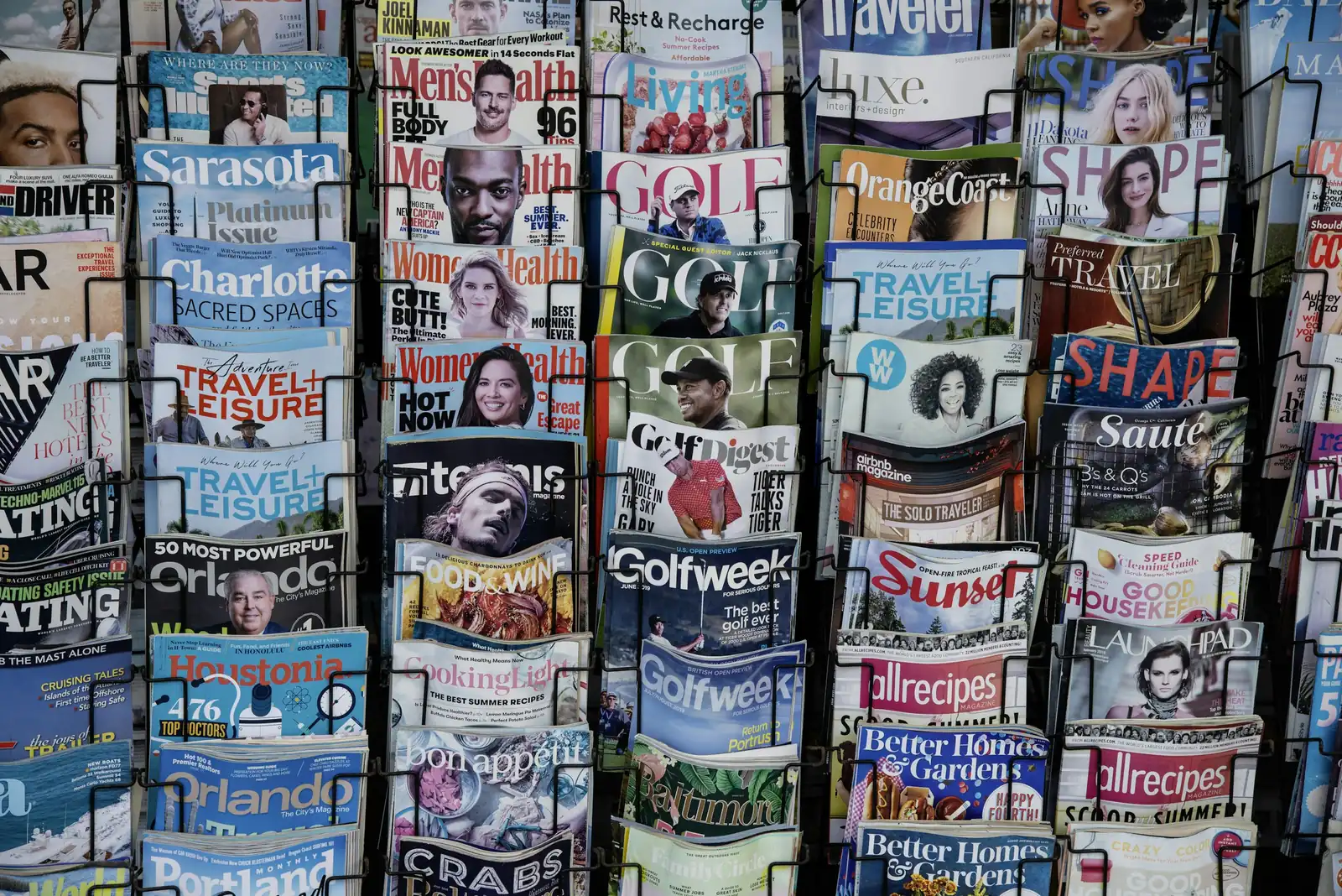 A stack of newspapers on a rack.